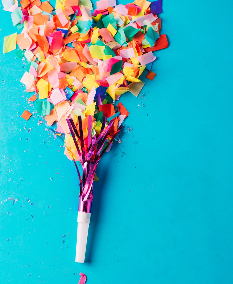 Confetti and Foil Tassel on Blue Background